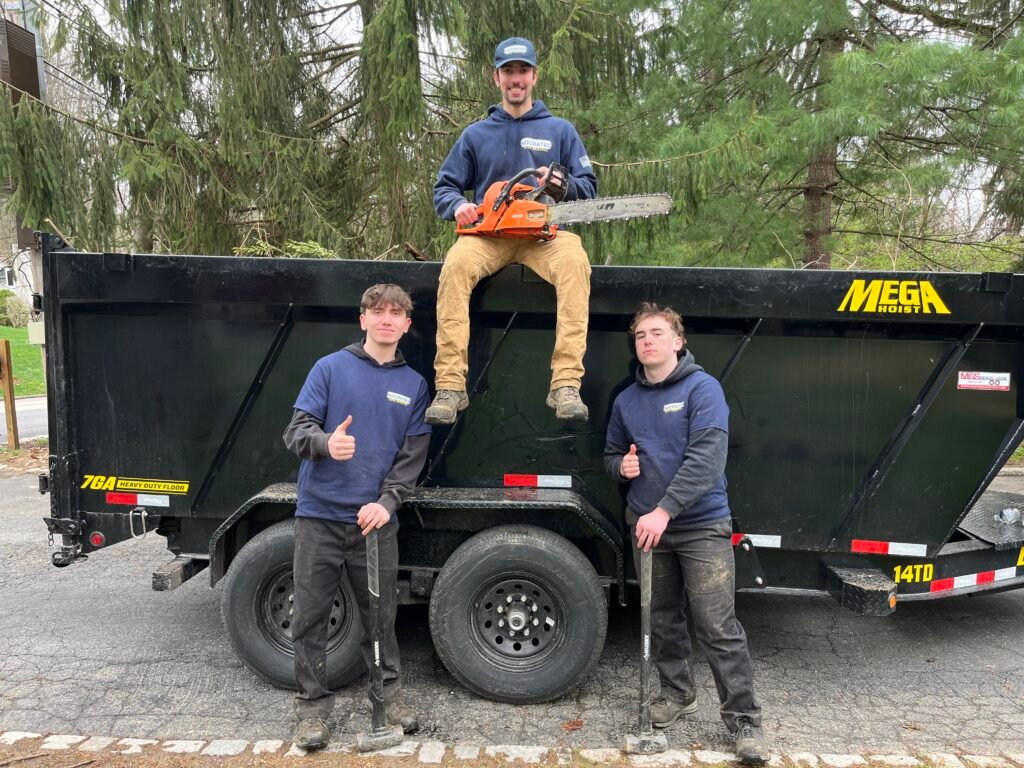 Socrates Junk Removal team performing light demolition with tools and dump trailer in the Wayne area