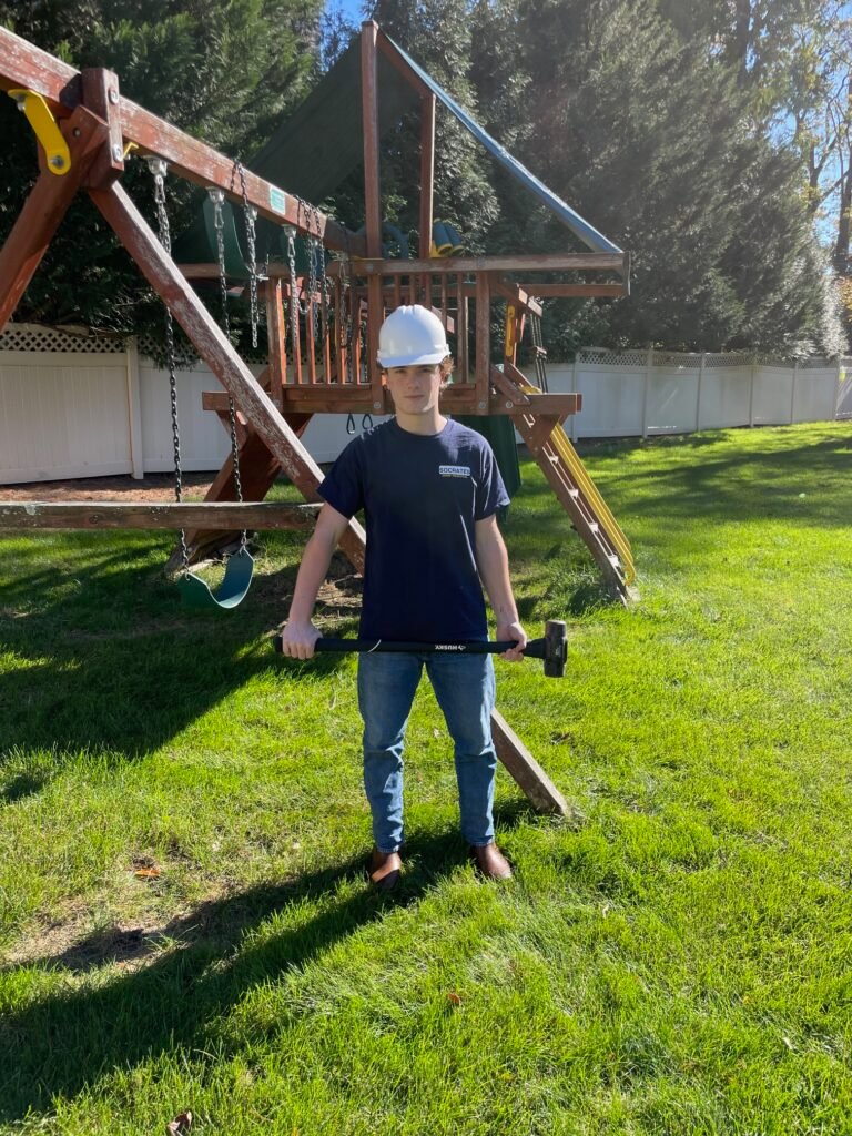 socrates junk removal crew member at property before swingset removal