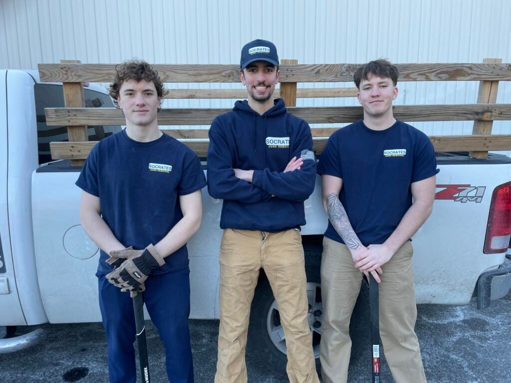 socrates junk removal crew in malvern by trailer at job site