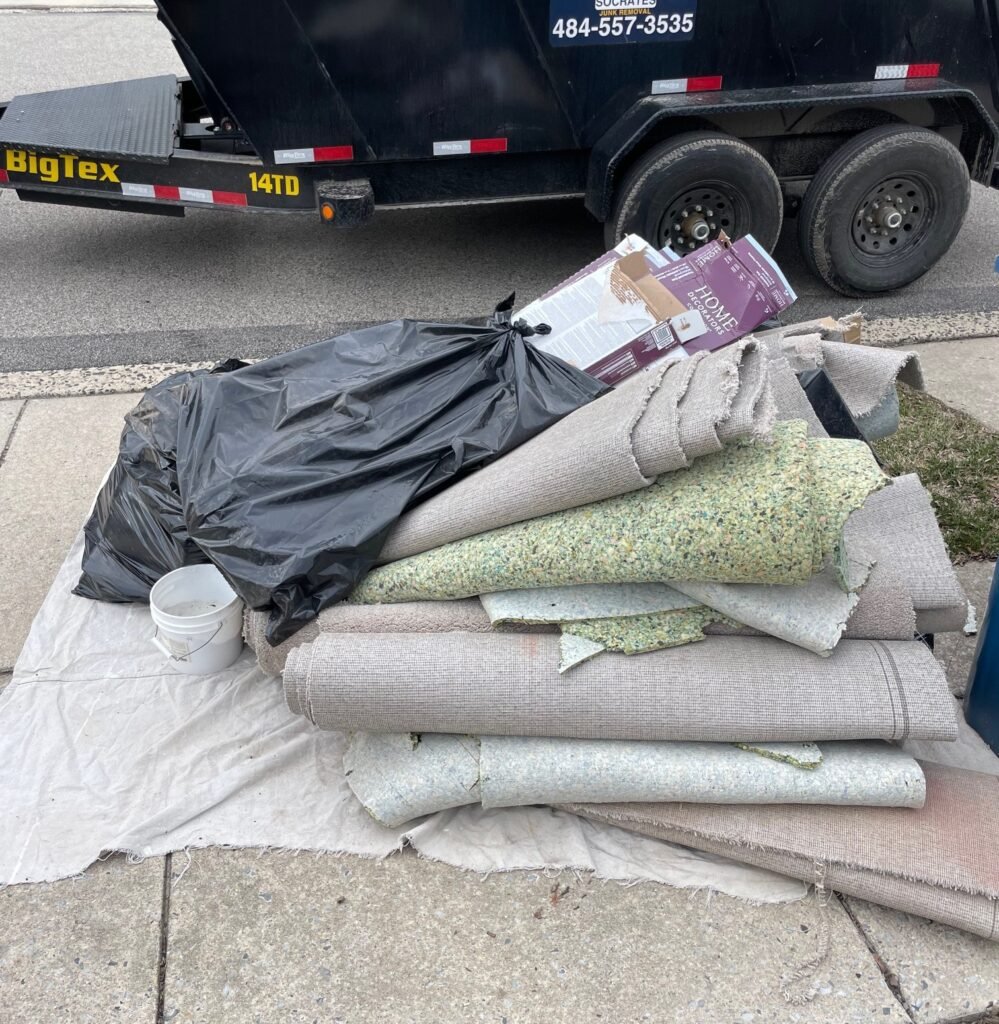bulk trash pickup carpet padding bags and debris piled for junk removal in wayne pa