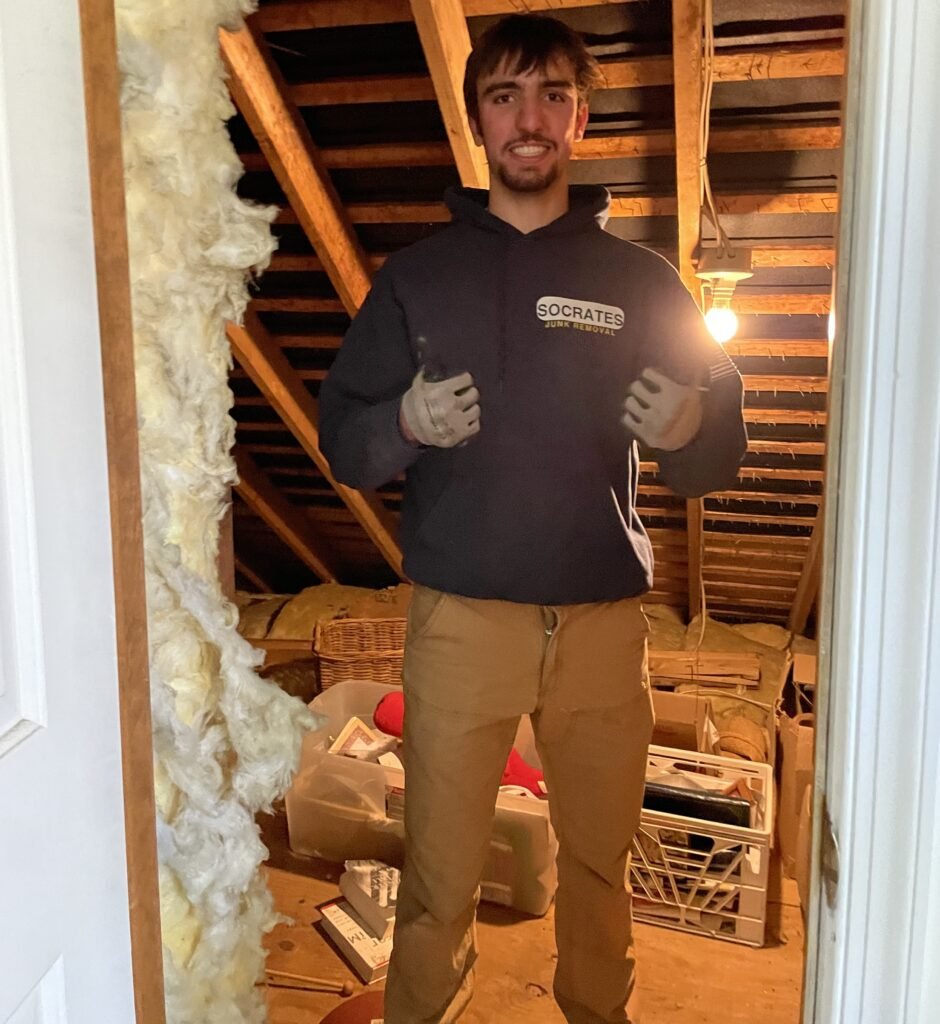 Attic cleanout in the Wayne area with Socrates Junk Removal team removing debris and clutter from attic space