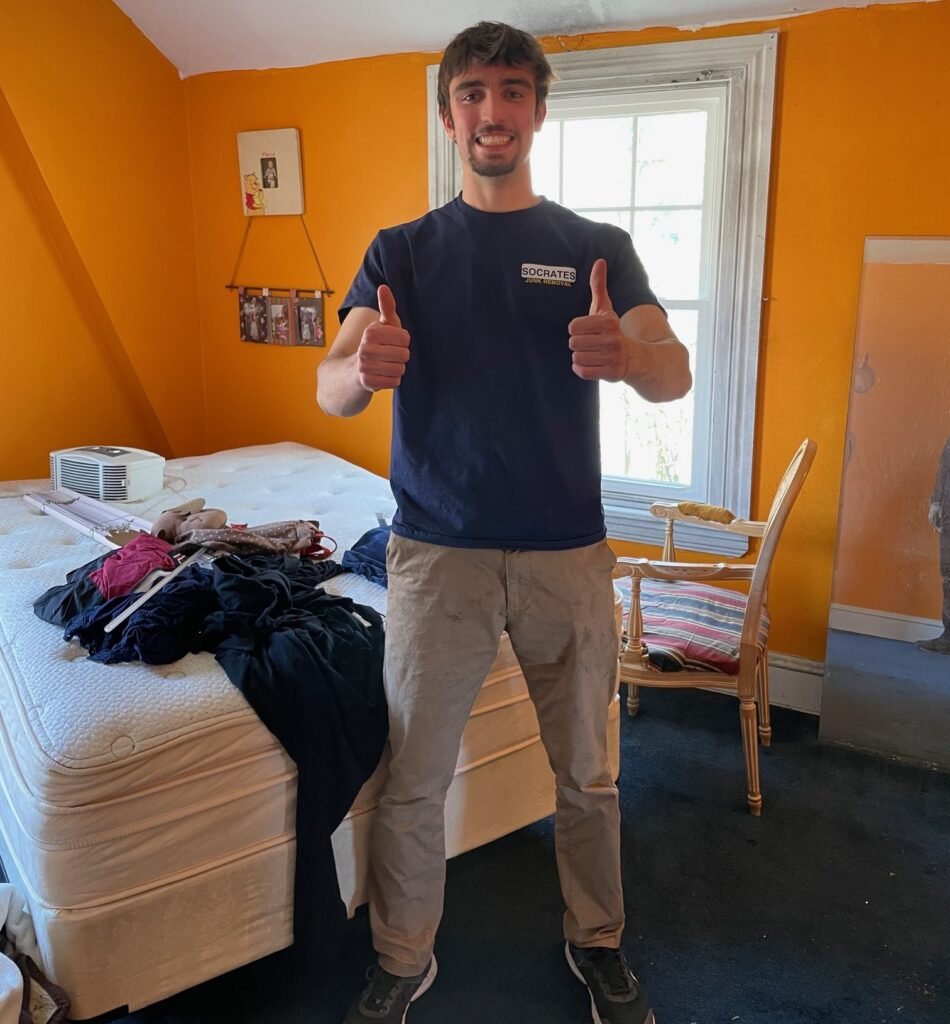 Socrates Junk Removal team member removing a mattress during a cleanout in King of Prussia, PA