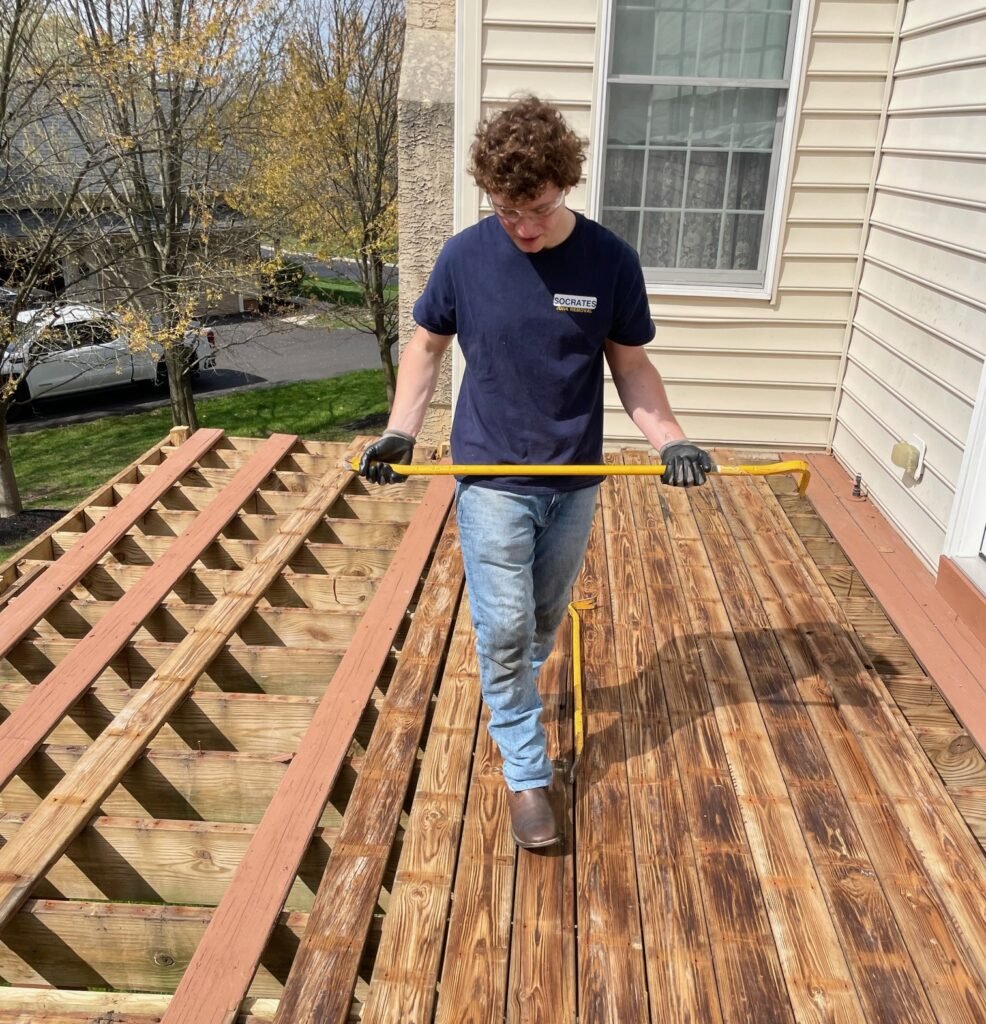 Socrates Junk Removal team member performing deck demolition in Phoenixville, PA
