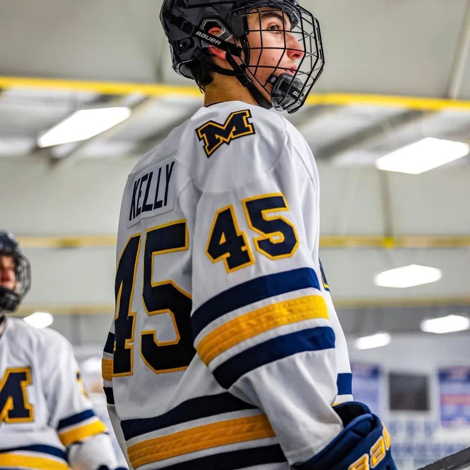 Socrates Kelly playing hockey in game wearing number 45 jersey