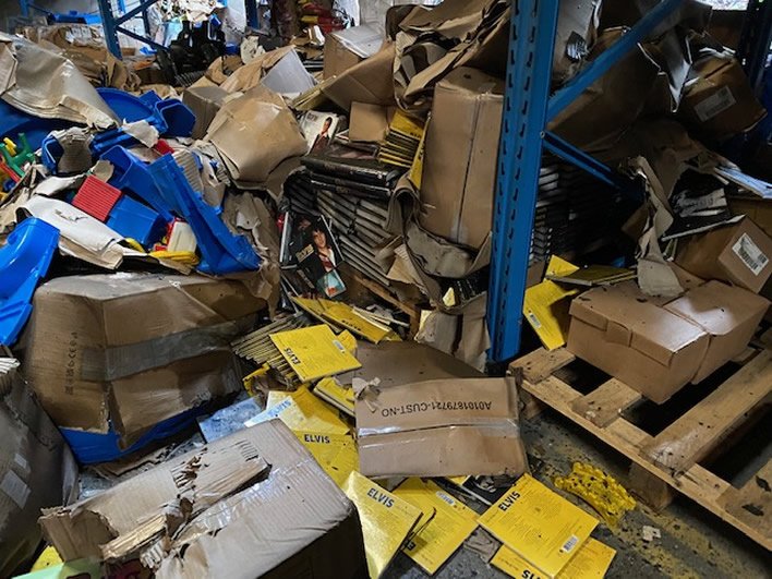 warehouse cleanout pallets shelving and bulk debris being removed from facility
