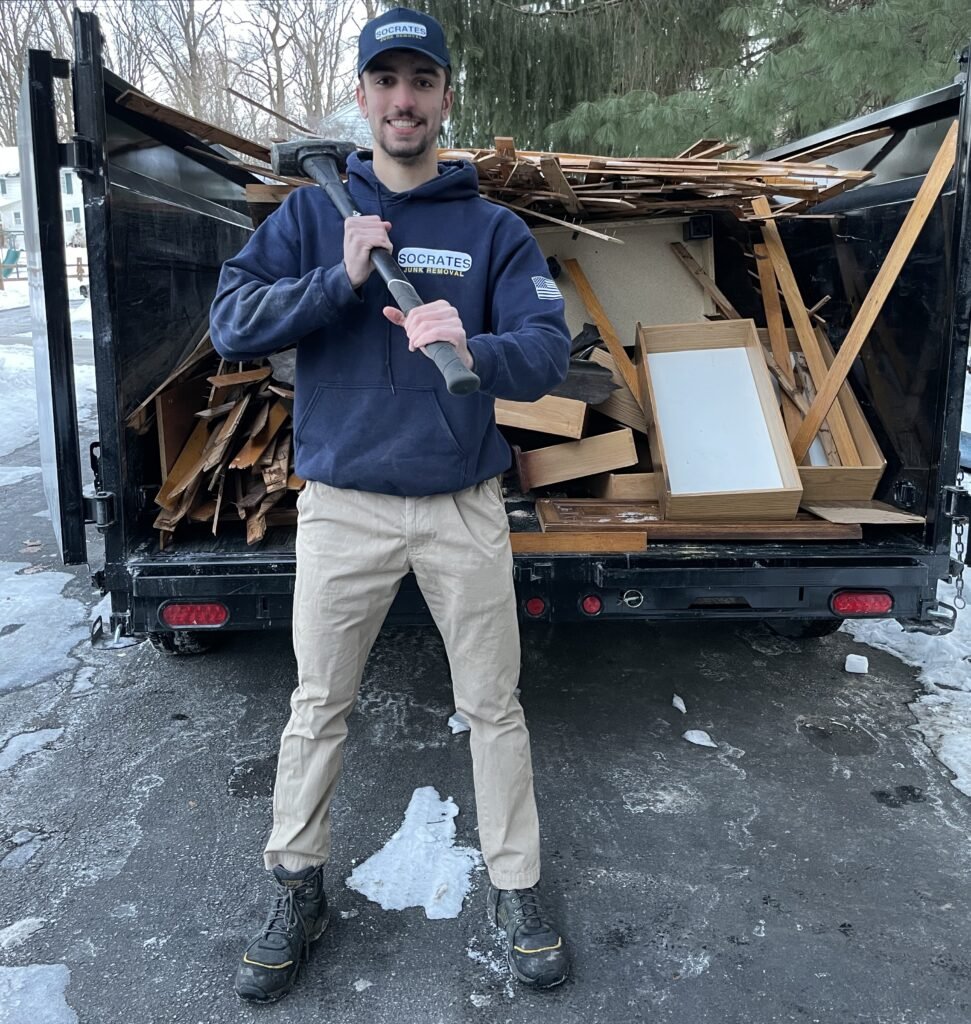 Socrates Junk Removal owner standing in front of loaded dumpster trailer during cleanout service in West Chester PA