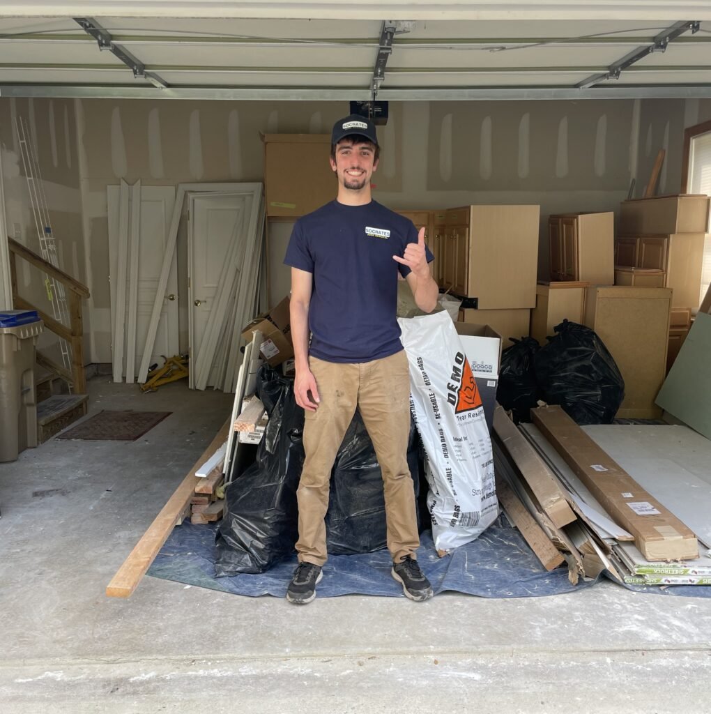 Socrates Junk Removal owner during garage cleanout and construction debris removal service in Thorndale PA
