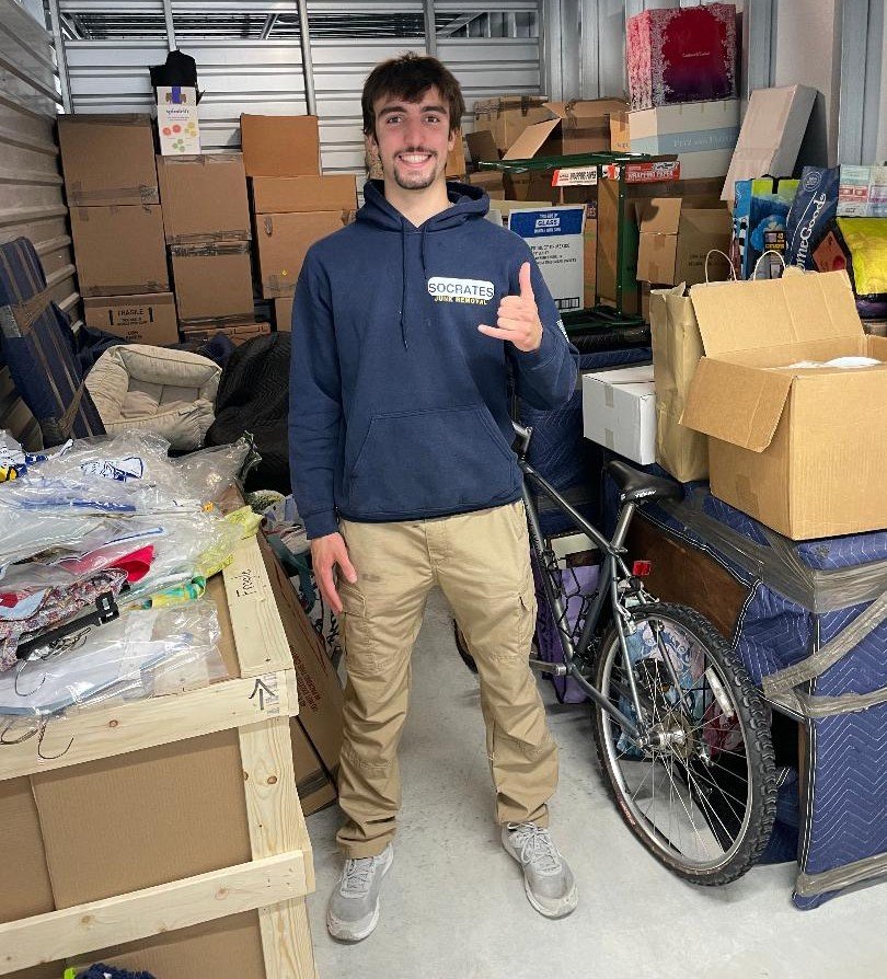 Socrates Junk Removal owner inside storage unit during cleanout service in Media PA