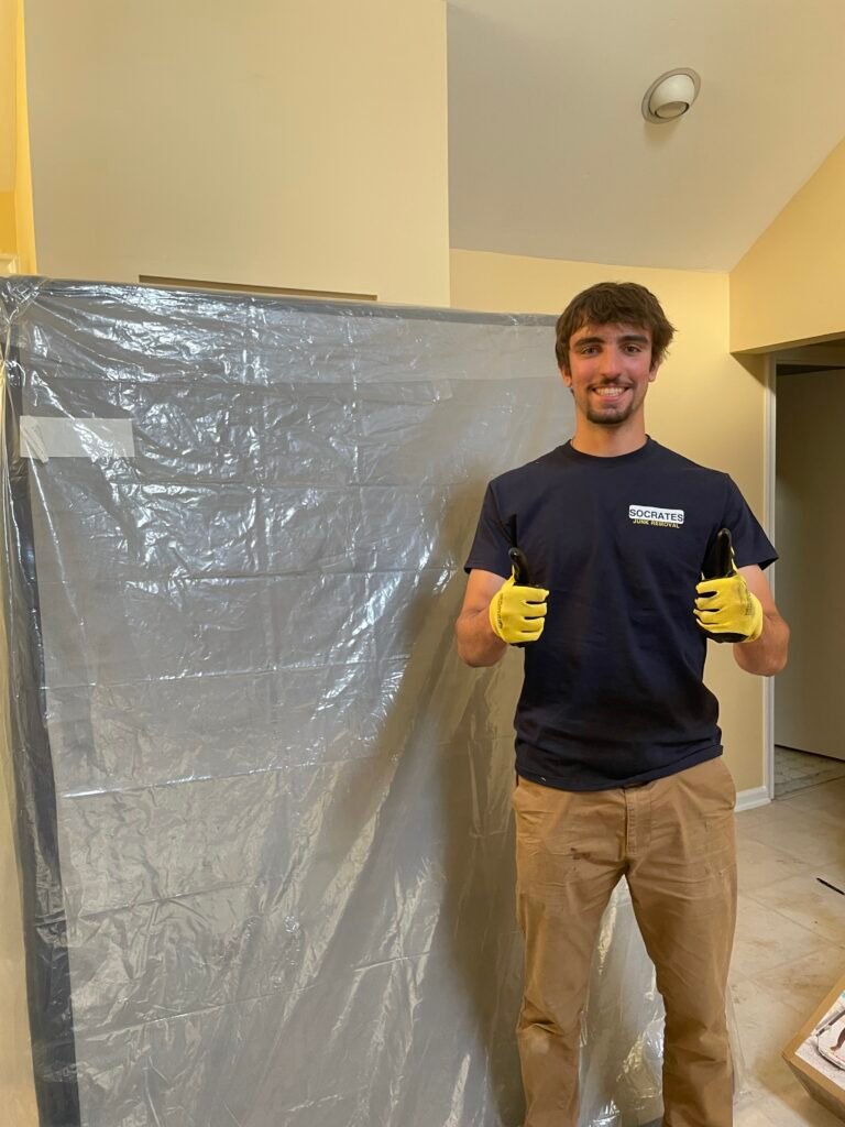 Socrates Junk Removal crew giving thumbs up during a hoarder cleanout in a Wayne PA attic